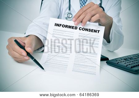 a doctor in his office showing an informed consent document and pointing with a pen where the patient must to sign