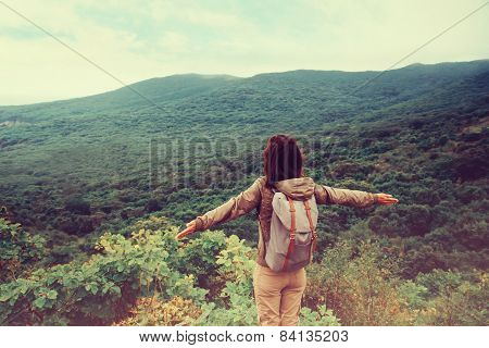 Traveler Girl Standing With Raised Arms On Mountain