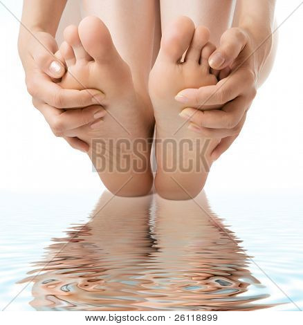 woman massage feet in water