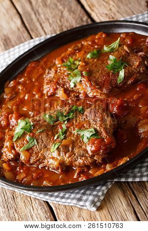 Swiss Steak Is Meat Beef Braising In A Pan Of Stewed Tomatoes, Mushroom Sauce Closeup. Vertical