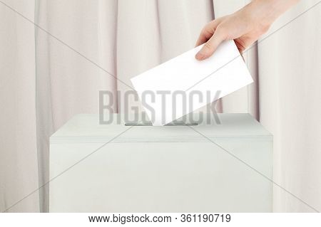 Vote Concept. Voter Hand Holding Ballot Paper For Election Vote On Polling Station