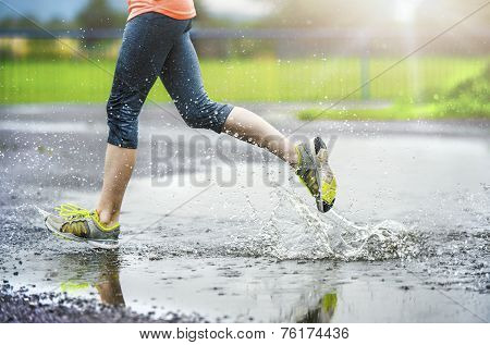 Girl of woman running in rainy weather - detail