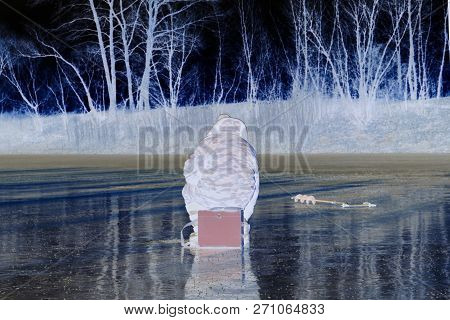 Abstraction. Fisherman Sitting On The Ice On The Lake. Abstraction As Art. A Different View Of The W