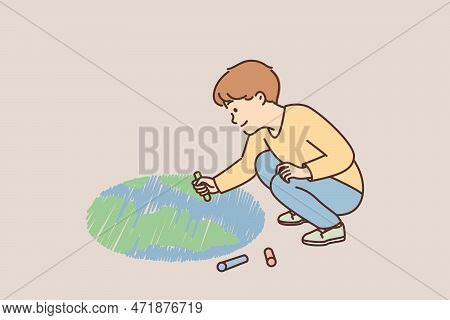 Smiling Little Boy Child Drawing Planet On Ground With Chalks. Happy Kid Have Fun Paint Earth On Str