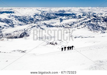 People Climbing Silhouette On Snow In Mountains