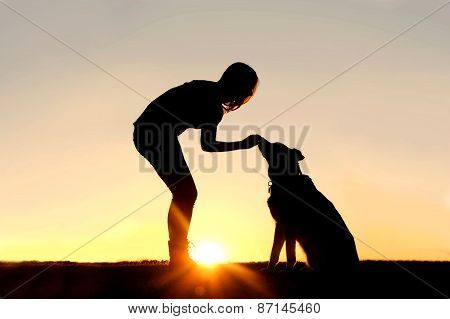 Woman Feeding Pet Dog Treats Silhouette