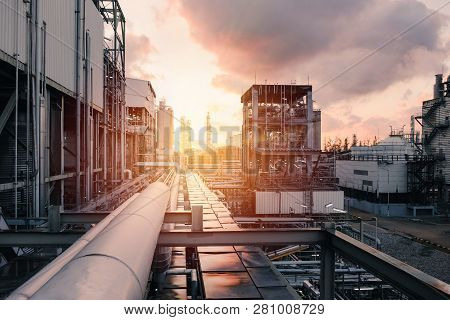 Pipeline And Pipe Rack Of Industrial Plant With Sunset Sky Background, Manufacturing Of Petrochemica