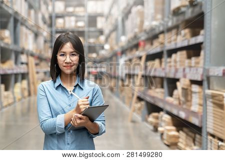 Young Attractive Asian Worker, Owner, Entrepreneur Woman Holding Smart Tablet Looking At Camera With