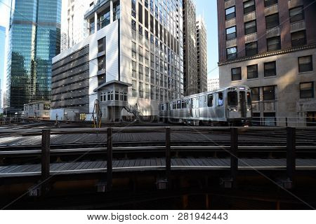 Commuter Train Turning The Corner On An Elevated Train Track Railroad Track Interchange Surrounded B