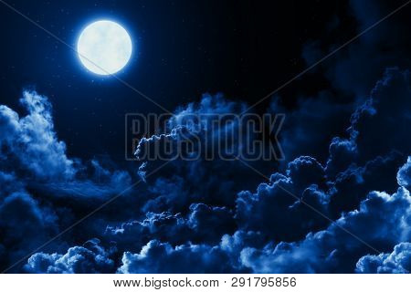 Mystical Bright Full Moon In The Midnight Sky With Stars Surrounded By Dramatic Clouds. Dark Natural