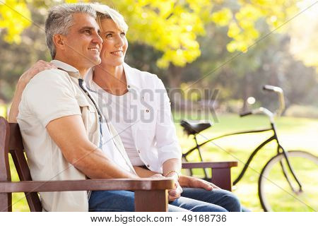 beautiful elegant mid age couple daydreaming retirement outdoors