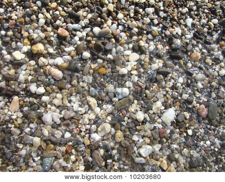 Background.Pebble em uma praia na água do mar