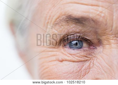 age, vision and old people concept - close up of senior woman face and eye