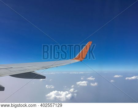 Passenger Aircraft Clouds Cape With White Airplane Is Flying In The Daytime Sky Overcast