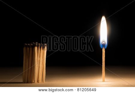 Crowd Of Burnt  Matches Standing Before Match On Fire Concept Of Motivation Leadership