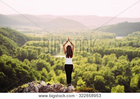 Attractive Woman Doing Yoga. Healthy Lifestyle. The Concentration Of The Body. Woman Doing Yoga In T