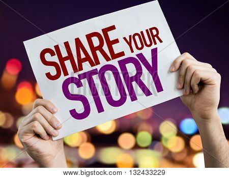 Share Your Story placard with night lights on background