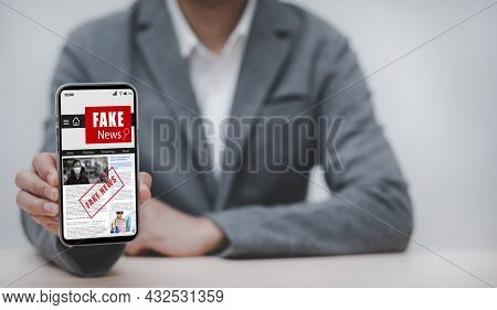 Fake News Online On Smartphone Concept, Businessman Reading Fake News Or Articles About Covid-19 In 