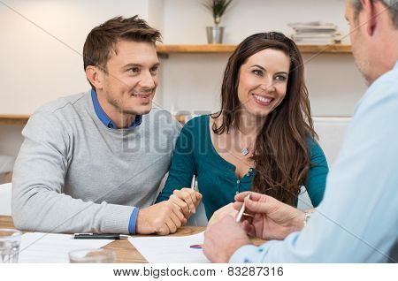 Young couple meeting financial advisor for investment
