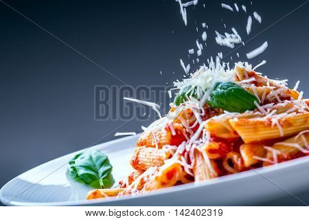 Pasta Penne with Tomato Bolognese Sauce Parmesan Cheese and Basil. Mediterranean food.Italian cuisine.