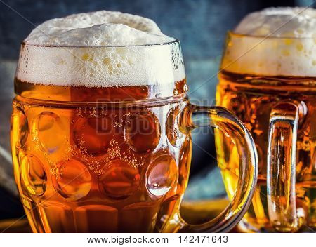 Beer. Oktoberfest.Two cold beers. Draft beer. Draft ale. Golden beer. Golden ale. Two gold beer with froth on top. Draft cold beer in glass jars in pub hotel or restaurant. Still life.