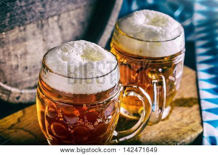 Beer. Oktoberfest.Two cold beers. Draft beer. Draft ale. Golden beer. Golden ale. Two gold beer with froth on top. Draft cold beer in glass jars in pub hotel or restaurant. Still life.