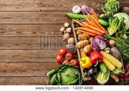 Assortment of  fresh vegetables  on wooden background