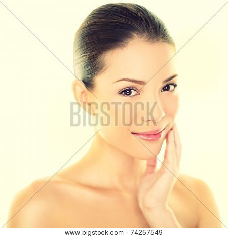 Woman beauty skincare woman touching perfect skin on face. Beautiful wellness beauty care and spa concept with multi-ethnic Chinese Asian / Caucasian girl with healthy glowing skin.