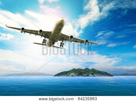 Passenger Plane Flying Over Beautiful Blue Ocean And Island In Purity Destination Sea Beach Use For