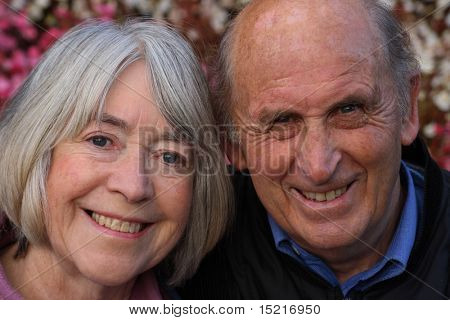 Happy mature couple in public gardens enjoying a day out.