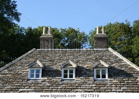 Traditional stone roof with three windows.