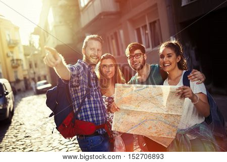 Happy cute tourists exploring travel destination city