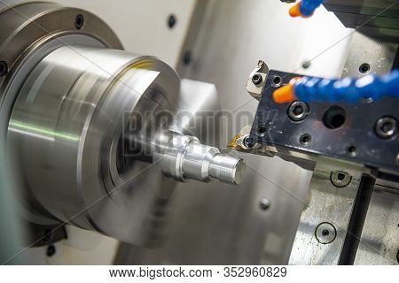 The Cnc Lathe Machine In Metal Working Process Cutting Thread The Metal Shaft Parts With In The Ligh