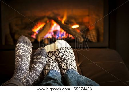 Feet Warming By Fireplace