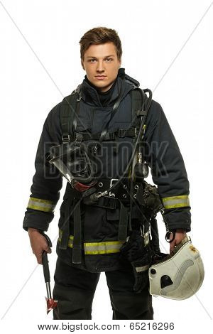 Young firefighter with helmet and axe isolated on white 