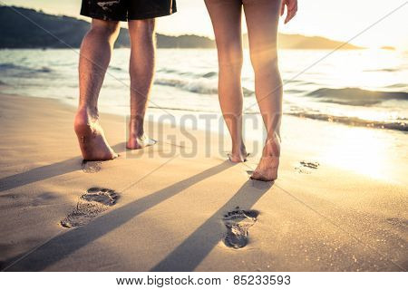 Lovers Walking On The Beach