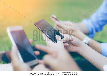 Hand of group business people using while reading smartphone. Portrait of Hand of group business people reading message with smart phone in outdoor.