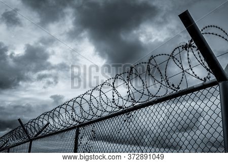 Prison Security Fence. Barbed Wire Security Fence. Razor Wire Jail Fence. Barrier Border. Boundary S