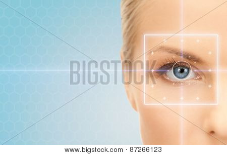 health, medicine, identity, vision and people concept - beautiful young woman with laser light lines on her eye over blue background