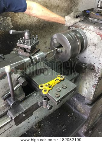 CNC lath machine (CNC Turning machine) while cutting steel metal shaft processing on lathe machine in workshop