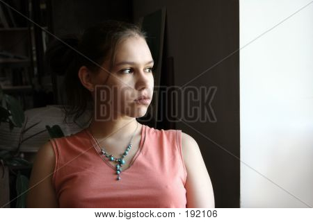 Unhappy Teen By The Window