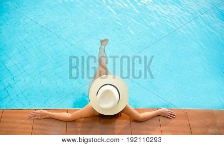 Asia woman lifestyle relaxing near luxury swimming pool sunbath summer day at the beach resort in the hotel. Concept Summer