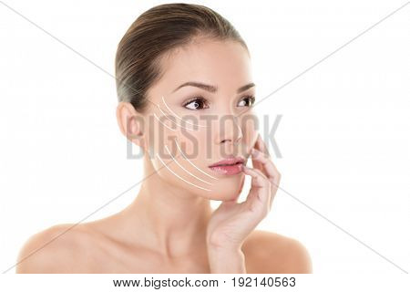 Face lift treatment anti aging skincare beauty woman concept. Skin care Asian model touching face with lifting arrows lines facelift design. Portrait in studio isolated on white background.