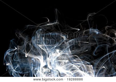 Wide wisps of smoke rising on black background