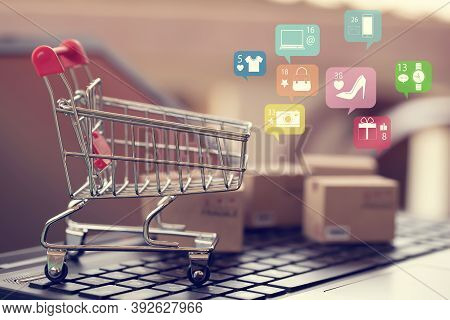 Shopping Online, E-commerce Concept:  Paper Shopping Bags On Notebook Keyboard. Depicts Purchase Of 