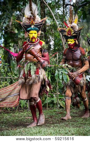 PAPUA, NEW GUINEA - OCTOBER 30: The men of the Huli tribe in Tari area of Papua New Guinea in traditional clothes and face paint on October 30, 2013. 