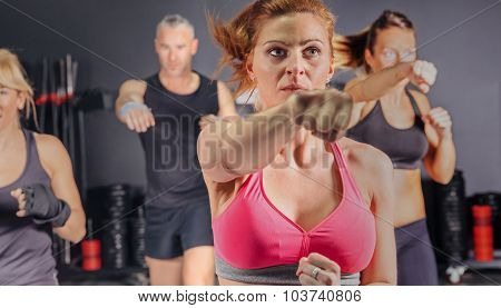 People in a boxing class training punch