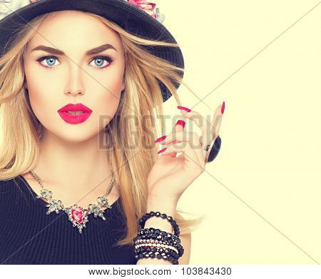 Beautiful sexy blonde woman with red lips and manicure in modern black hat. Beauty fashion model girl portrait with accessories- bracelets, necklace and elegant hat