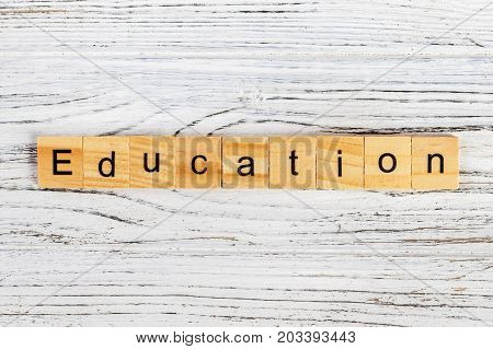 Wood block education word over backboard school. Education word formed by educational wood block. Education word concept for background.