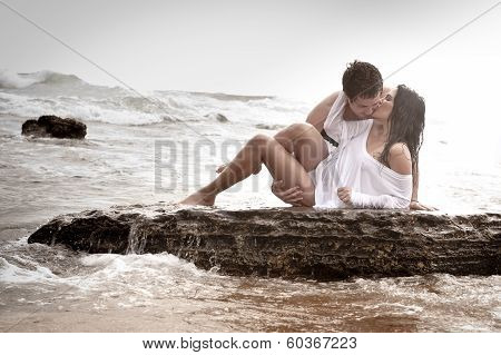 young sexy couple kisisng on beach